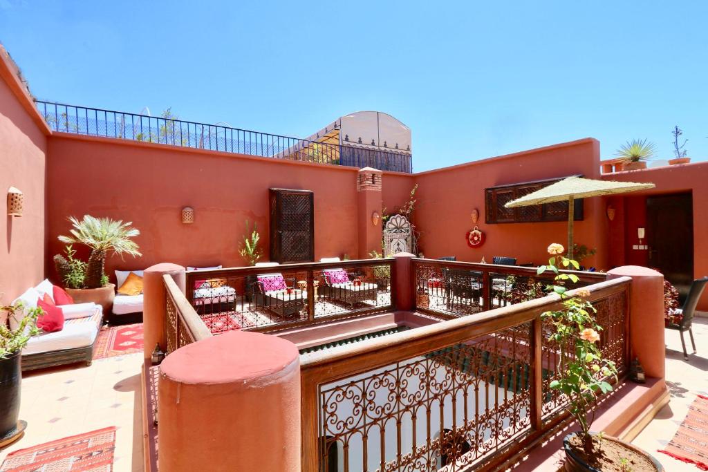 a balcony with an outdoor seating area on a building at Dar Pamella in Marrakesh