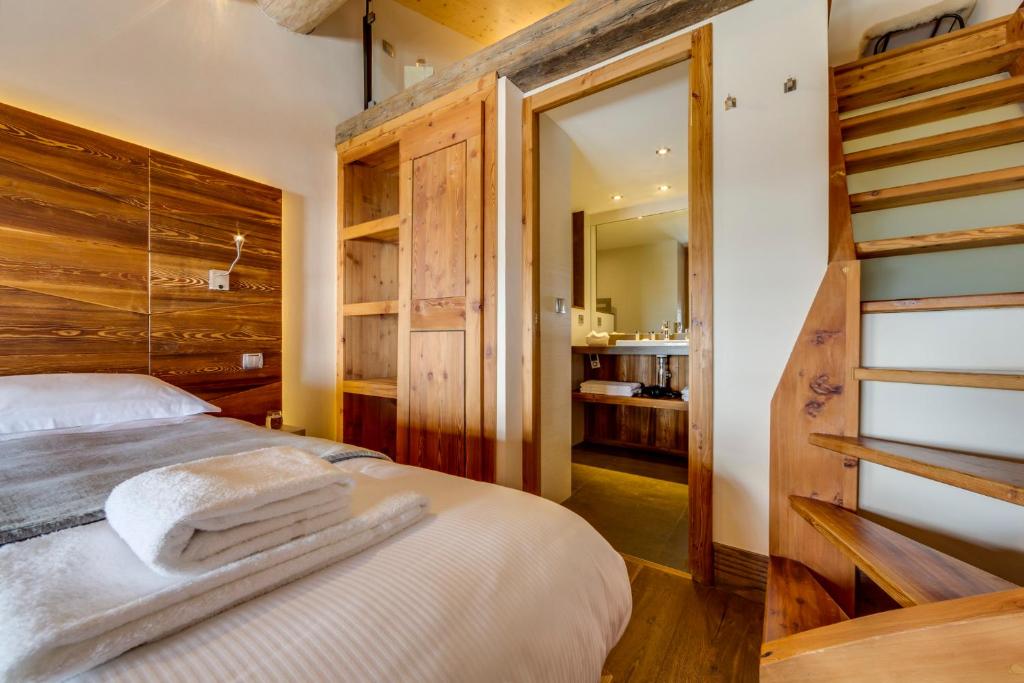 Postel nebo postele na pokoji v ubytování Chalet Hotel Du Fornet