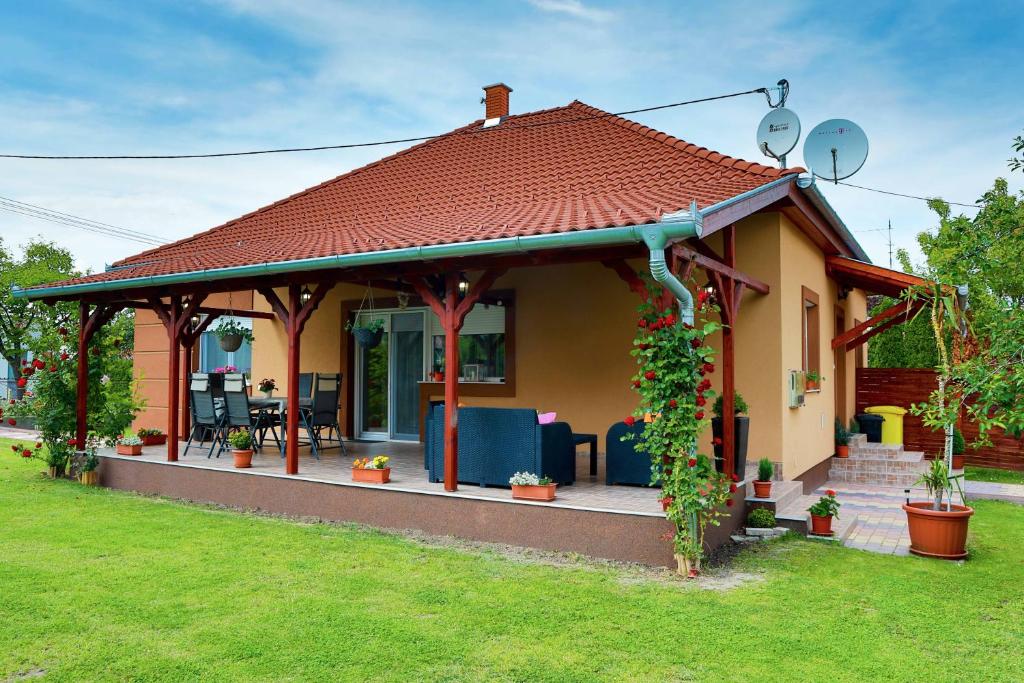 una pequeña casa con cenador en un patio en Villa Eszter, en Balatonkeresztúr
