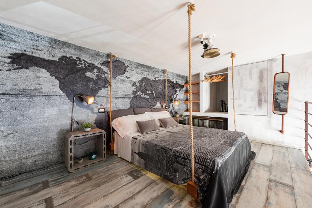 una camera da letto con letto a dondolo e murale di The Loft Polignano a Polignano a Mare