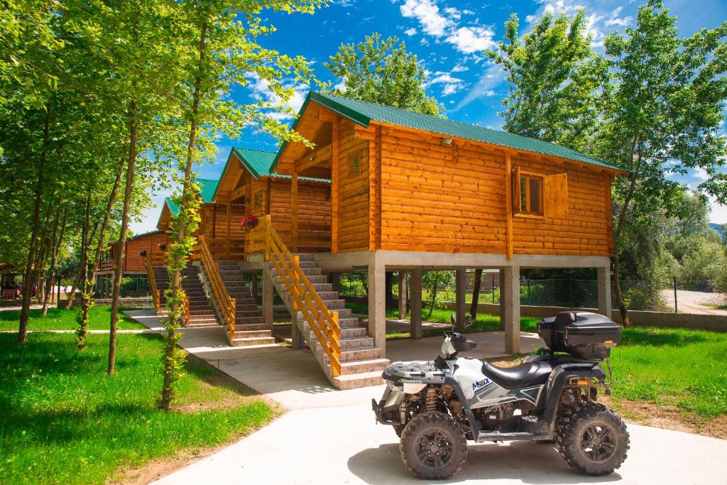 a motorcycle parked in front of a tiny house at Ethno village Moraca - Skadar lake in Vranjina