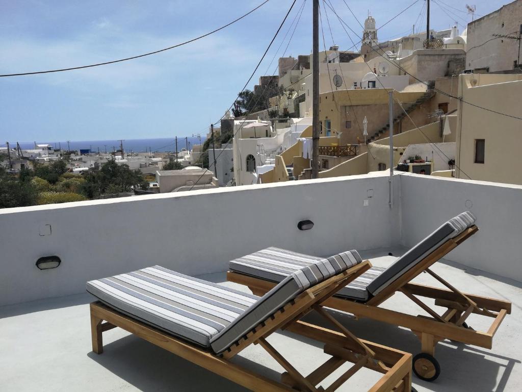 a lounge chair on the roof of a house at Katsinaros House in Emporio