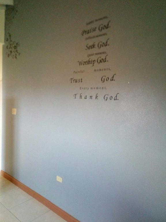 a wall with writing on a wall at Spring Top Cottage in Falmouth