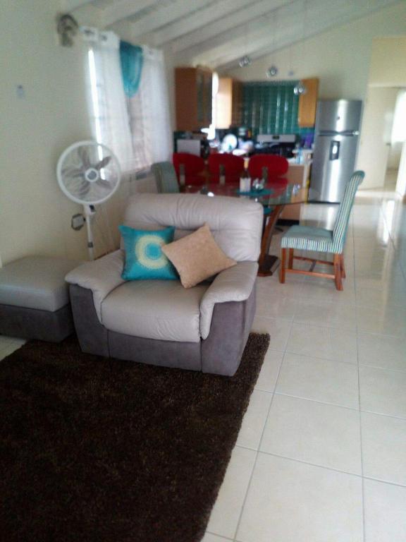 a living room with a couch and a chair at Spring Top Cottage in Falmouth