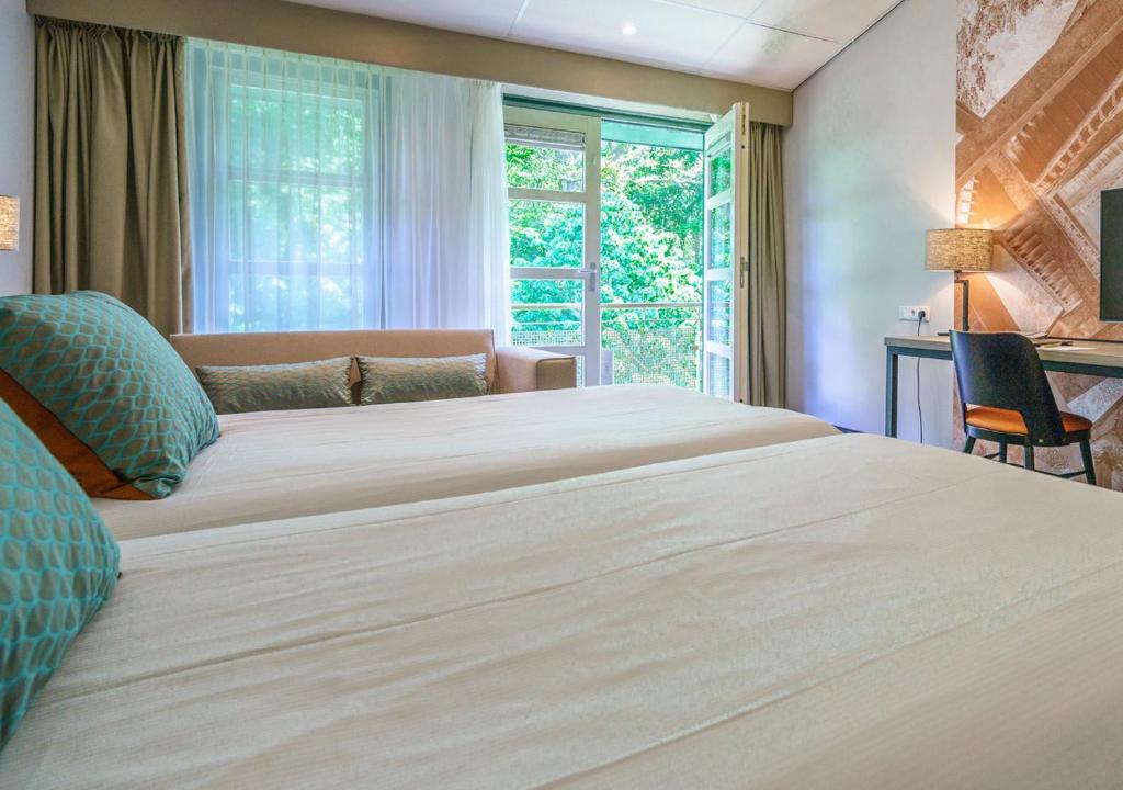 Postel nebo postele na pokoji v ubytování Parkhotel Tjaarda