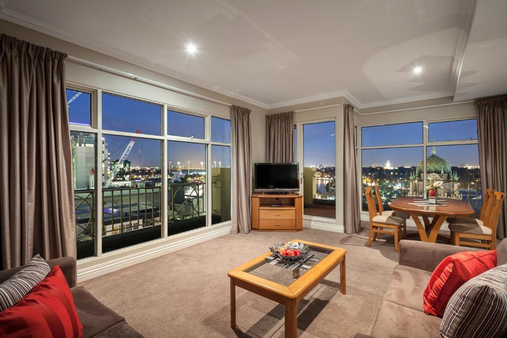 a living room with a view of a city at Flinders Landing Apartments in Melbourne
