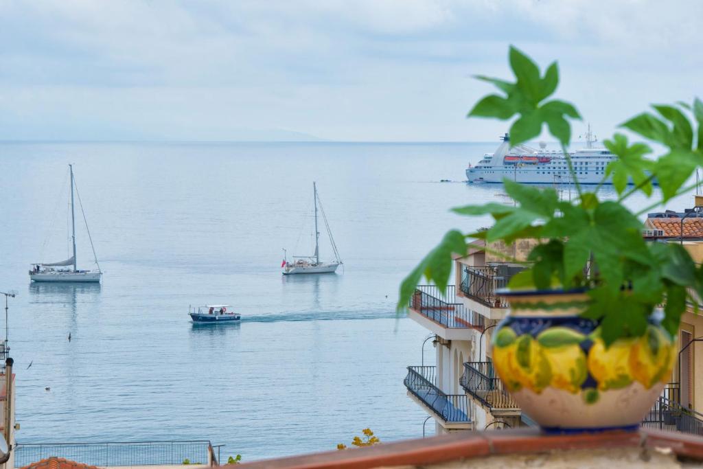a view of the ocean with boats in the water at Casa Maccers in Giardini Naxos