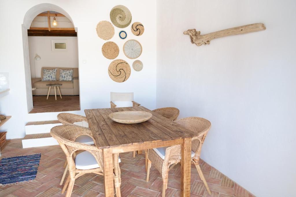 a dining room with a wooden table and chairs at Casas de Mértola 33 in Mértola
