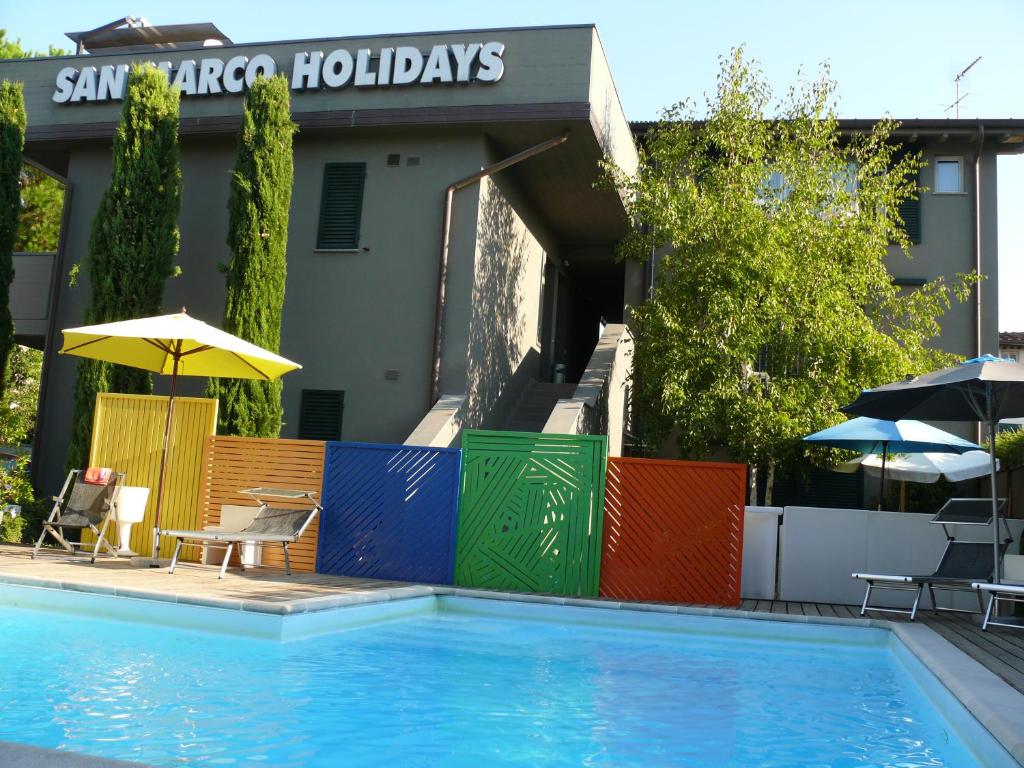 a swimming pool in front of a hotel at San Marco Holidays in Lucca