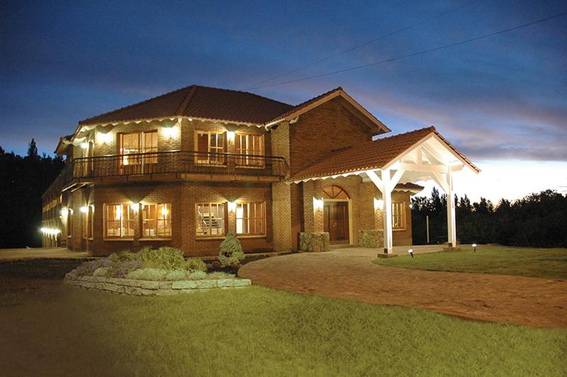 a large house with lights on top of it at La Barraca Resort in Merlo