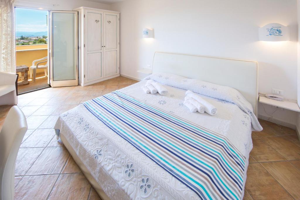 Postel nebo postele na pokoji v ubytování Olbia City Hotel