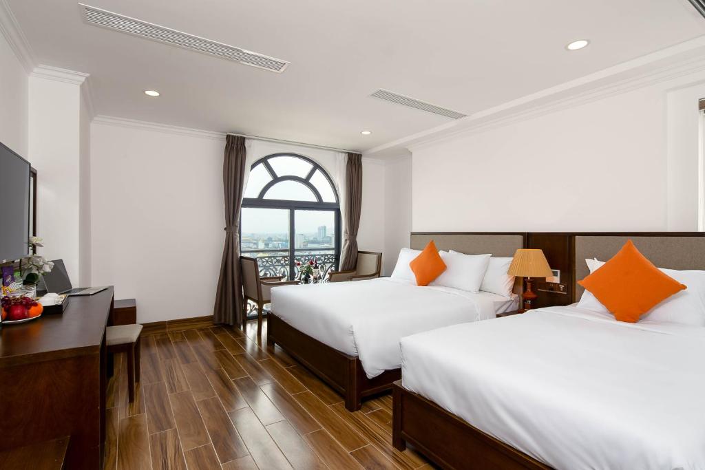Postel nebo postele na pokoji v ubytování Roliva Hotel & Apartment Danang