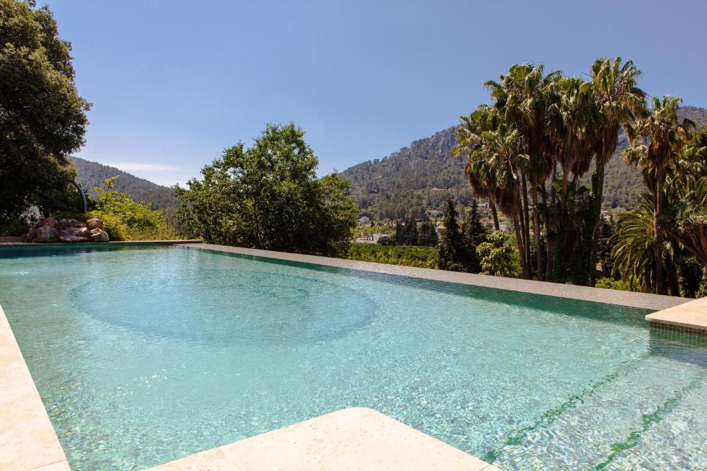 a swimming pool with a mountain in the background at Agroturismo Son Galceran in Esporles