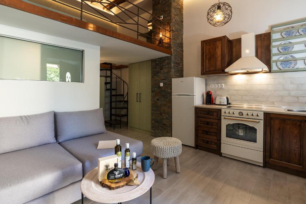 a living room with a couch and a kitchen at Casa Kariki - Traditional House in Psinthos in Psinthos