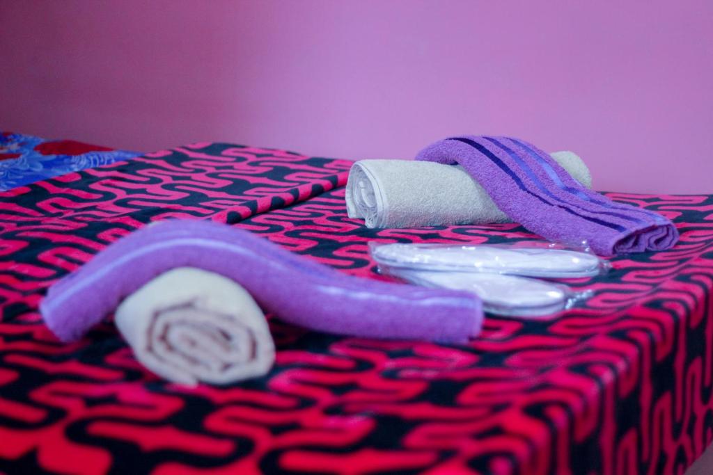 a bed with a purple towel and toilet paper on it at Galavani in Tbilisi City