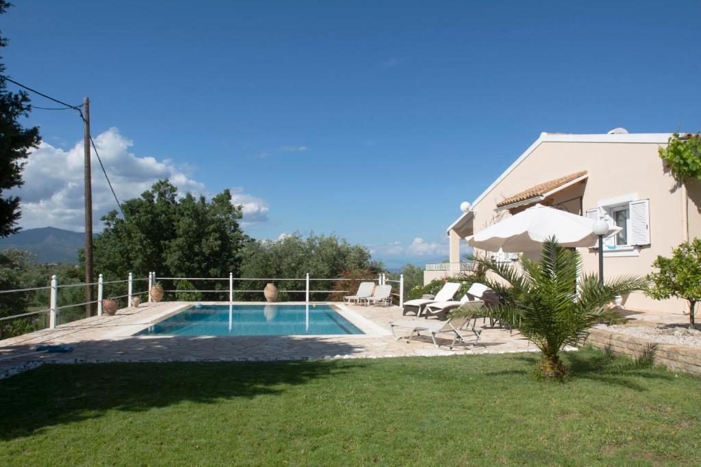 a villa with a swimming pool and a house at Oleander villa in Kouramaditika