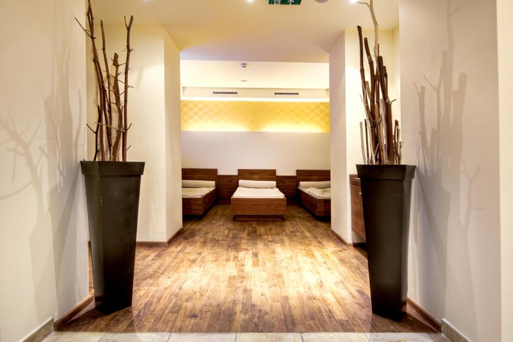 a waiting room with two large black vases at Hotel Brigitte in Ischgl