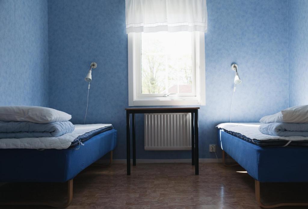 Postel nebo postele na pokoji v ubytování Visingsö Vandrarhem
