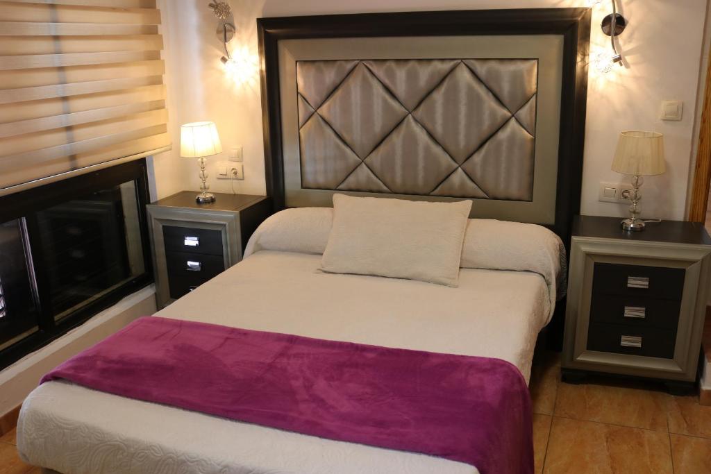 Postel nebo postele na pokoji v ubytování Apartamentos La Carmen