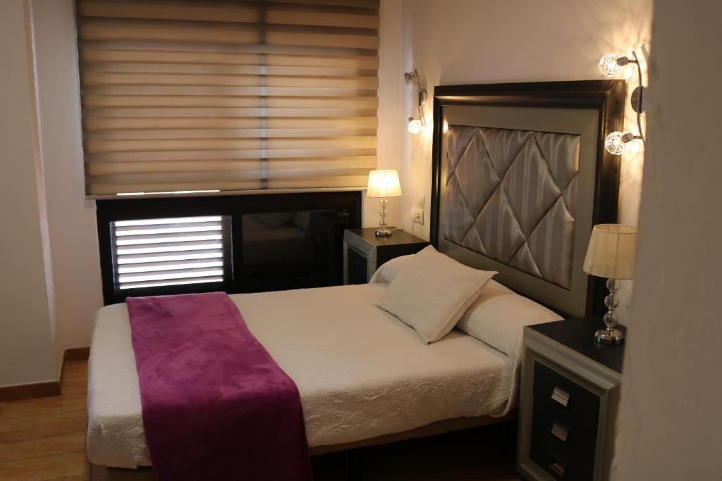 Postel nebo postele na pokoji v ubytování Apartamentos La Carmen