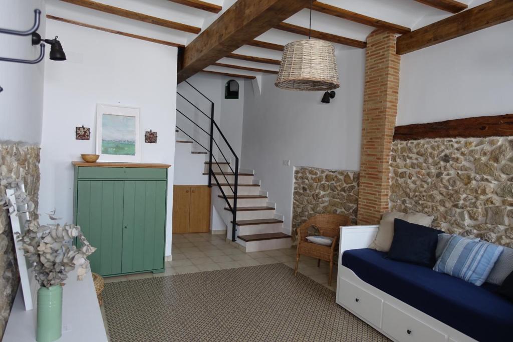 a living room with a green cabinet and stairs at Casa La Abuela in Chulilla