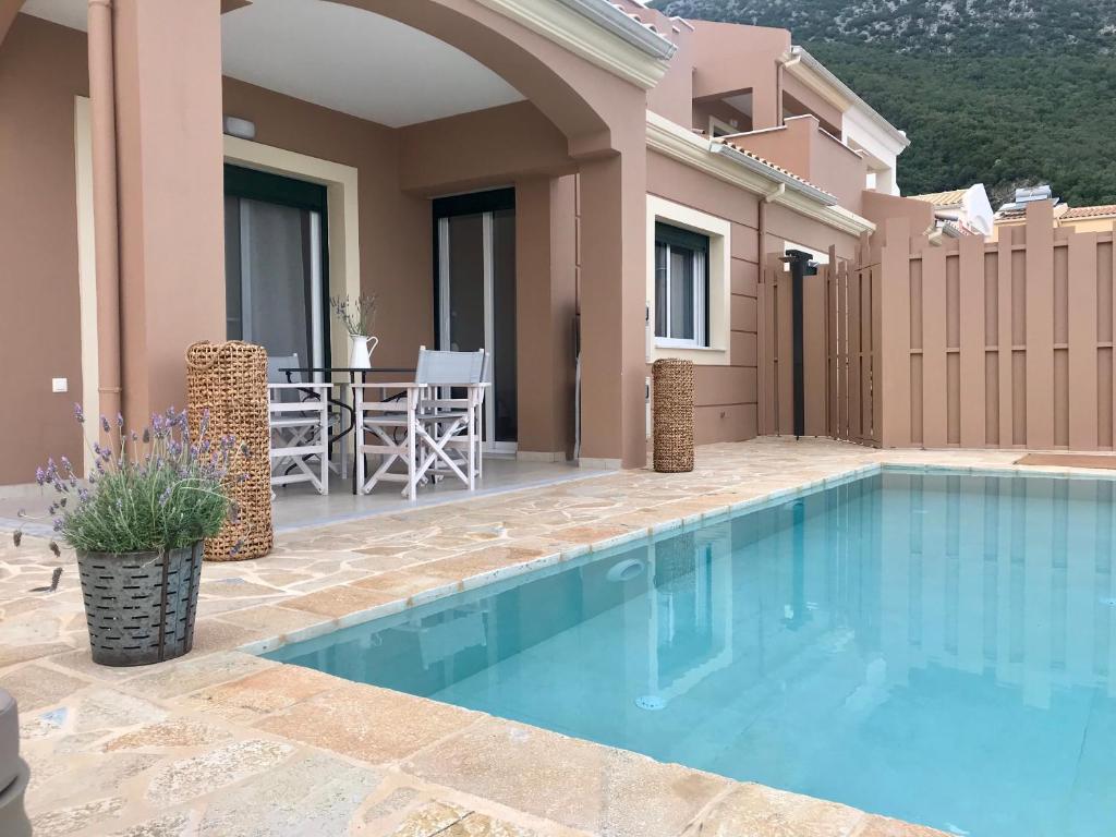 a swimming pool in front of a house at Villa Renata Gold in Barbati