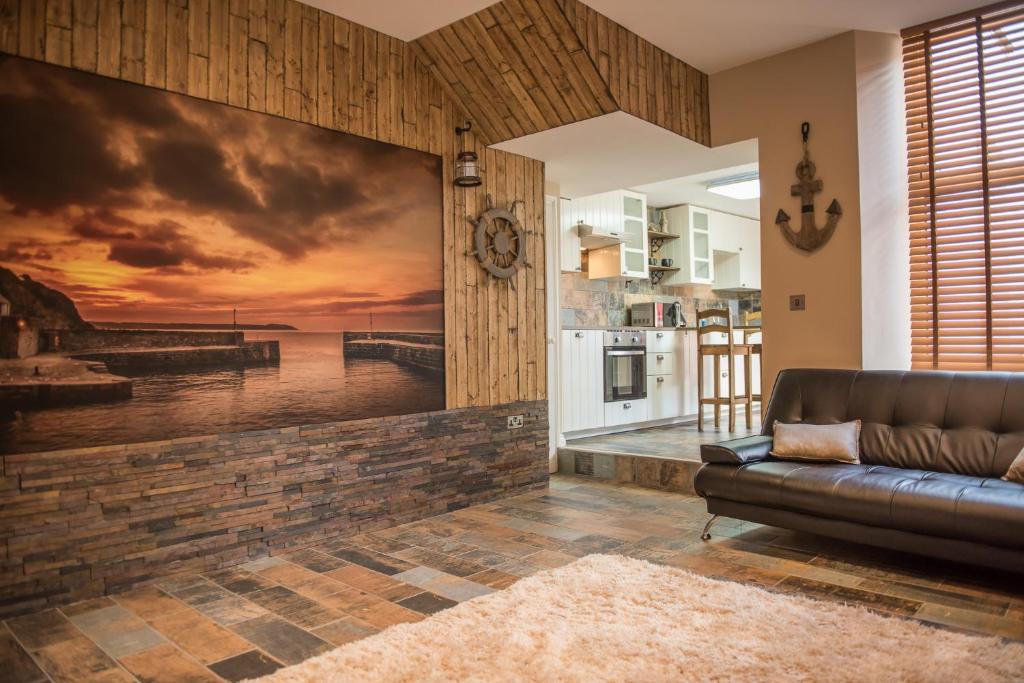a living room with a wall mural of a pier at Deluxe Rustic Charlestown Themed Apartment in St Austell