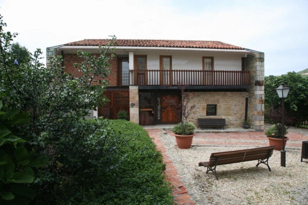 a house with a bench in front of it at Posada Los Calderones in Santillana del Mar