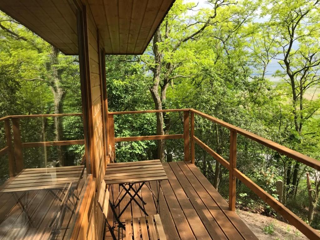 a porch of a cabin with a bench on it at Domki Skowronki in Kąty Rybackie