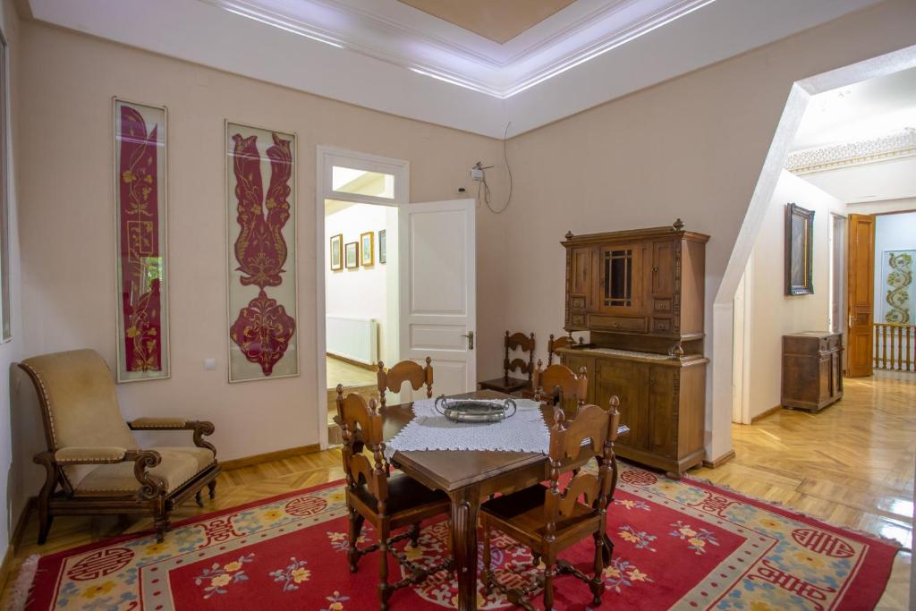 a dining room with a table and chairs in a room at HOTEL VENETO in Kutaisi