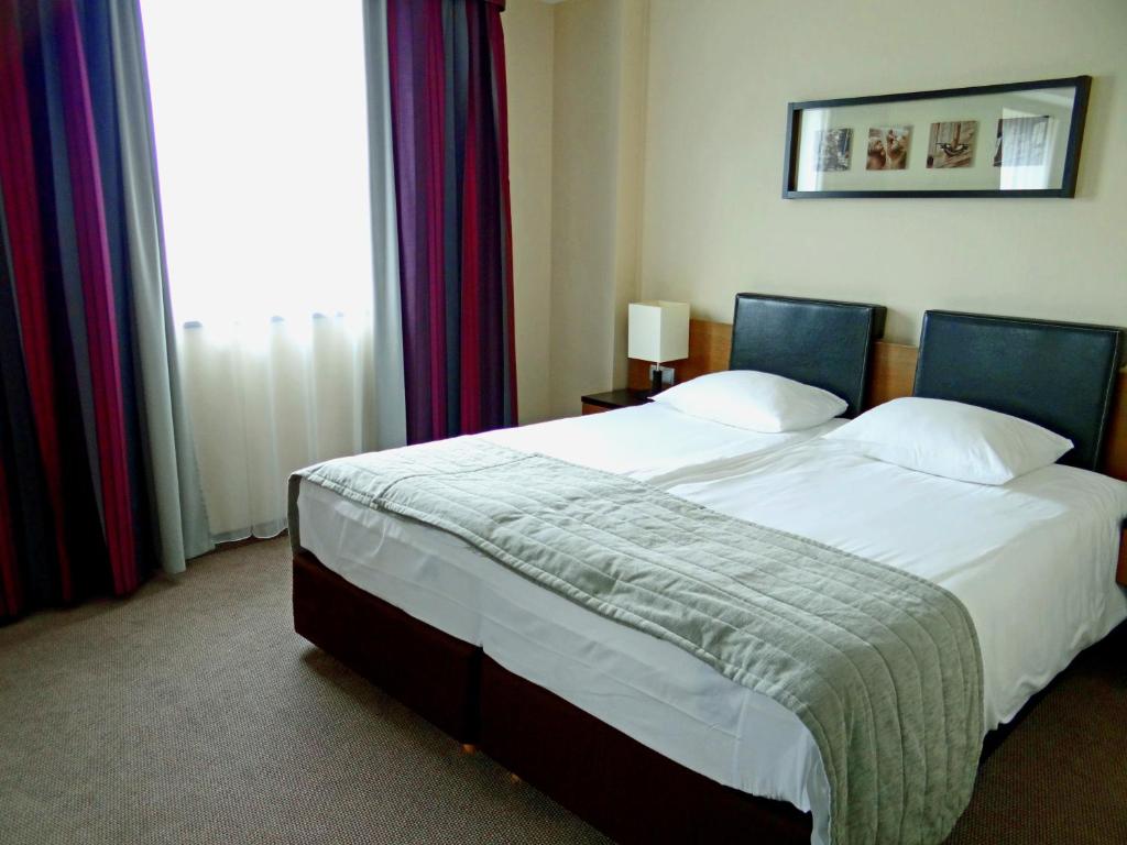Postel nebo postele na pokoji v ubytování Qubus Hotel Bielsko-Biała