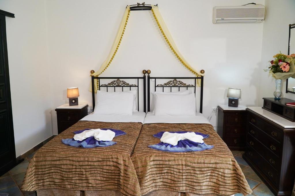 Postel nebo postele na pokoji v ubytování Vasilaras Hotel
