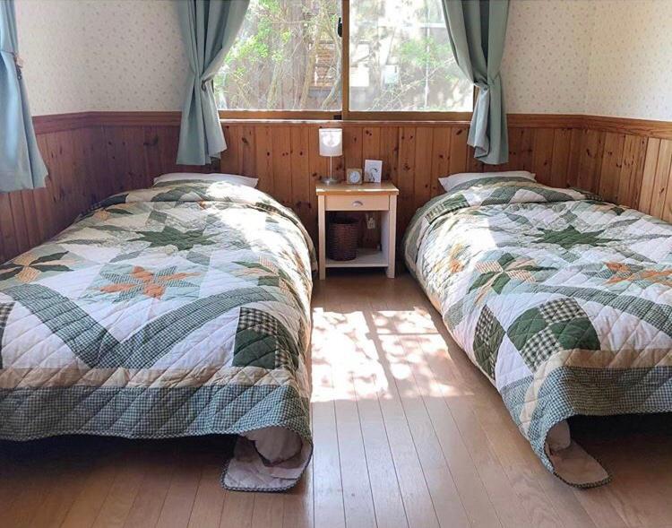 Postel nebo postele na pokoji v ubytování Guest House Chaconne Karuizawa