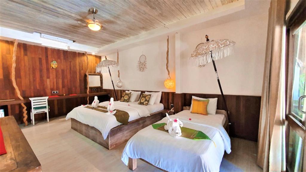 Postel nebo postele na pokoji v ubytování Samba Villas Beachfront View