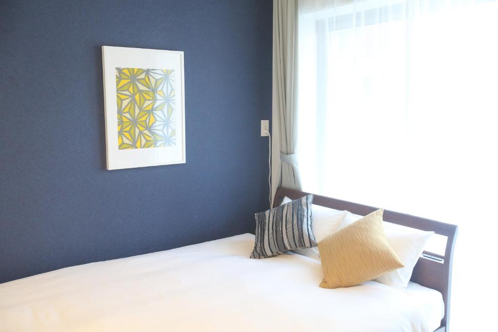 Postel nebo postele na pokoji v ubytování Apartment Hotel Tenjin TUMUGU