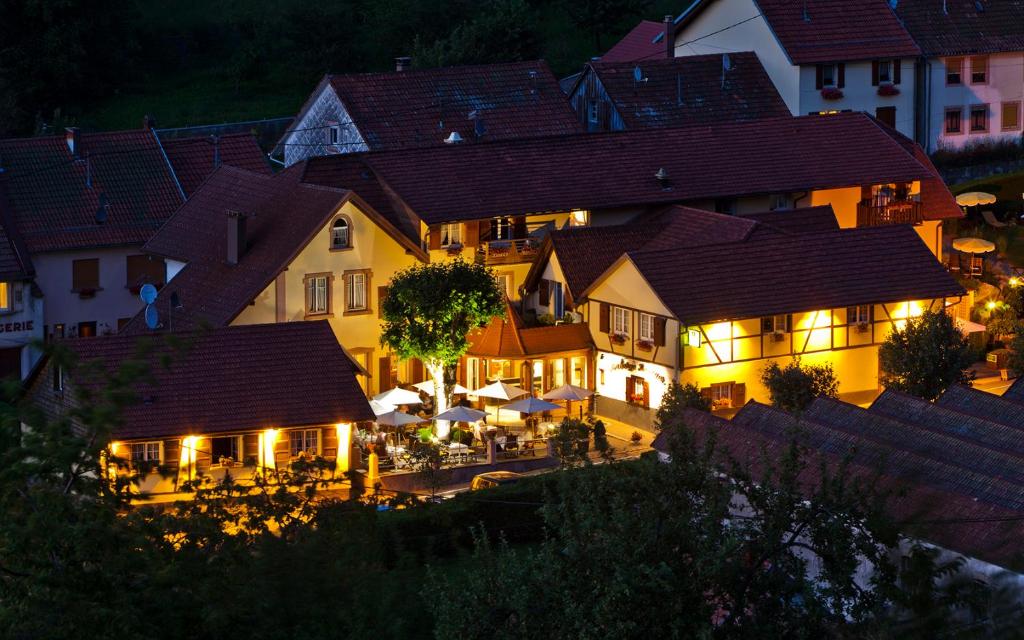 a view of a town at night with lights at Hotel Restaurant Auberge Metzger in Natzwiller
