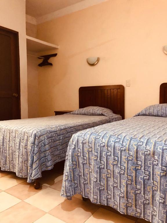 Postel nebo postele na pokoji v ubytování Hotel El Faro Malecon