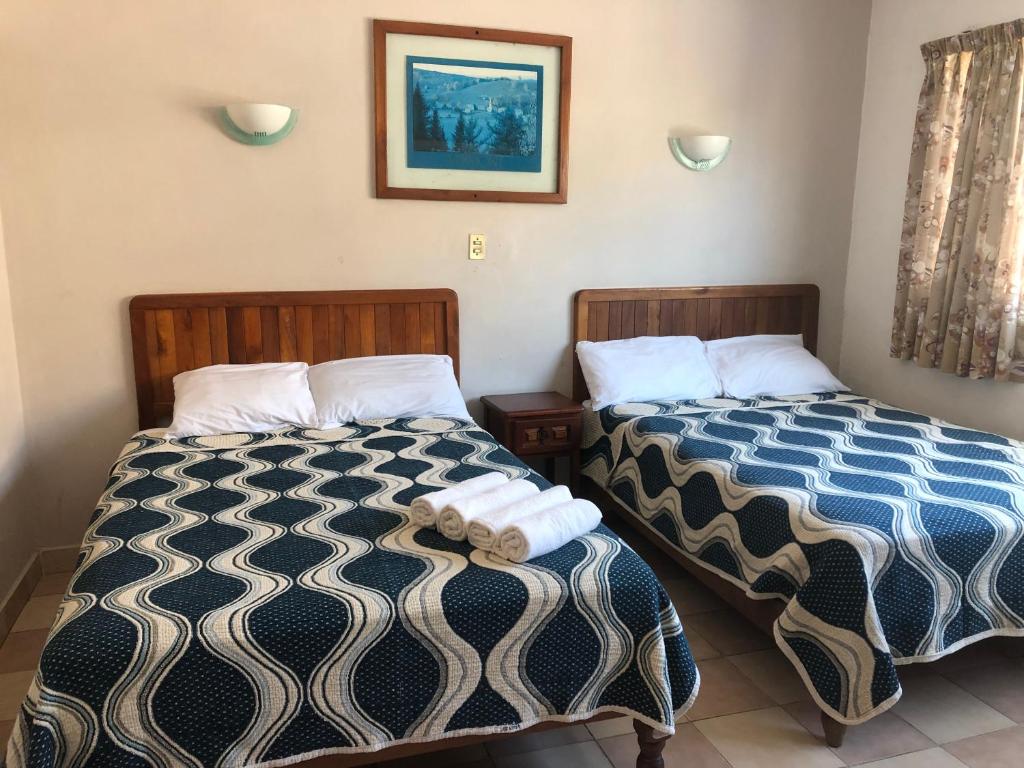 Postel nebo postele na pokoji v ubytování Hotel El Faro Malecon
