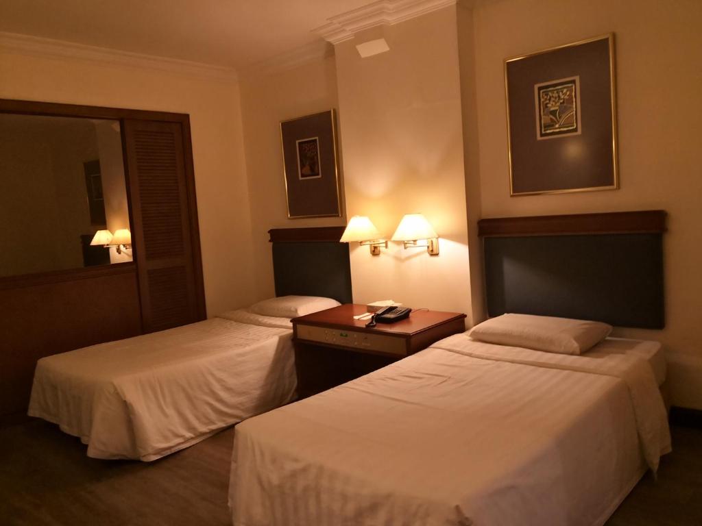 Postel nebo postele na pokoji v ubytování The Executive Hotel Lahad Datu