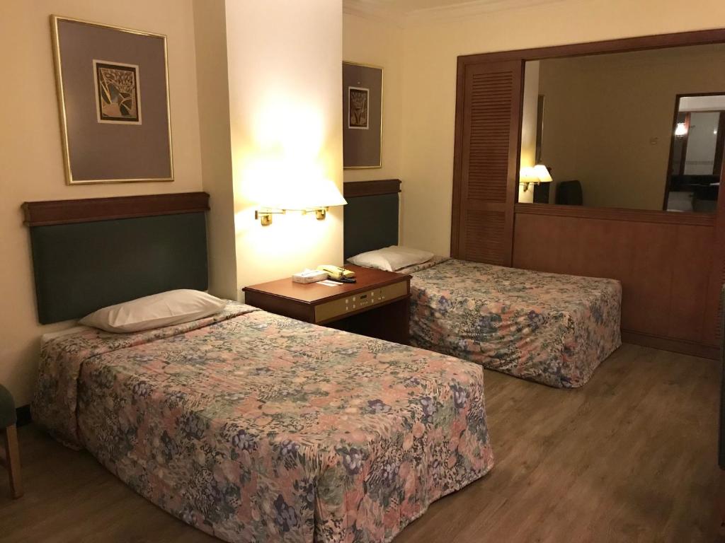 Postel nebo postele na pokoji v ubytování The Executive Hotel Lahad Datu