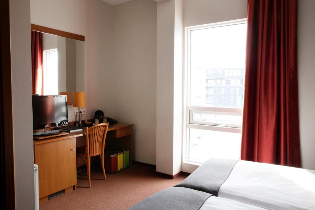 Postel nebo postele na pokoji v ubytování Fosshotel Baron