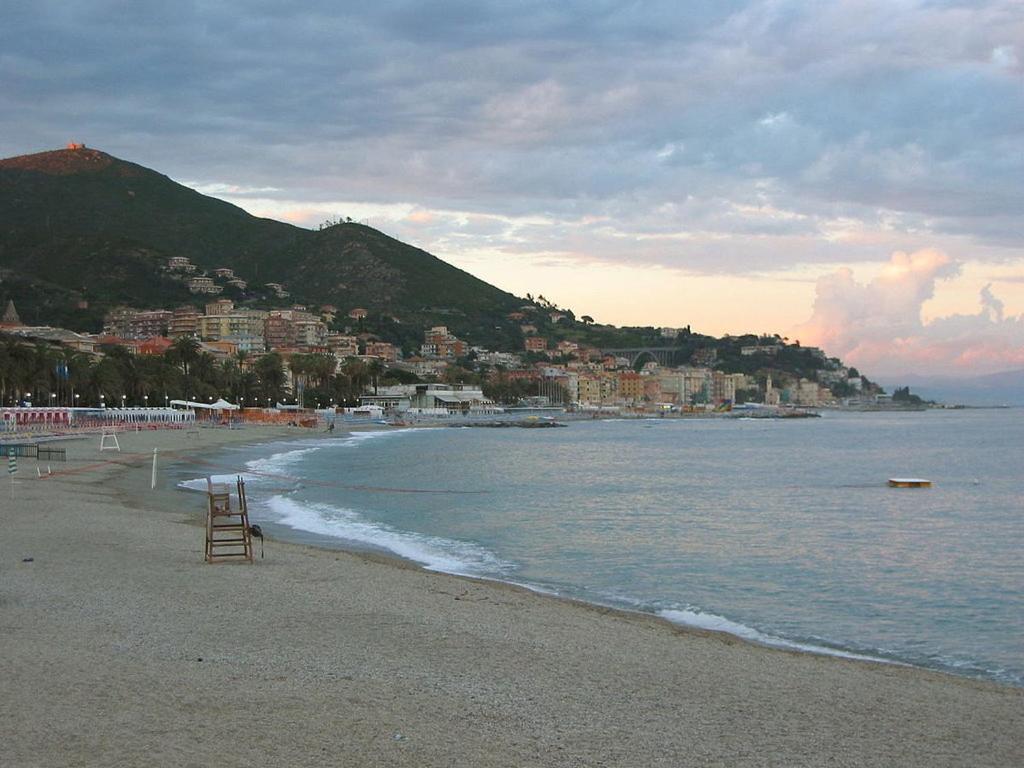 a beach with a view of the ocean and a city at Quiete ad un passo dal mare in Albisola Superiore