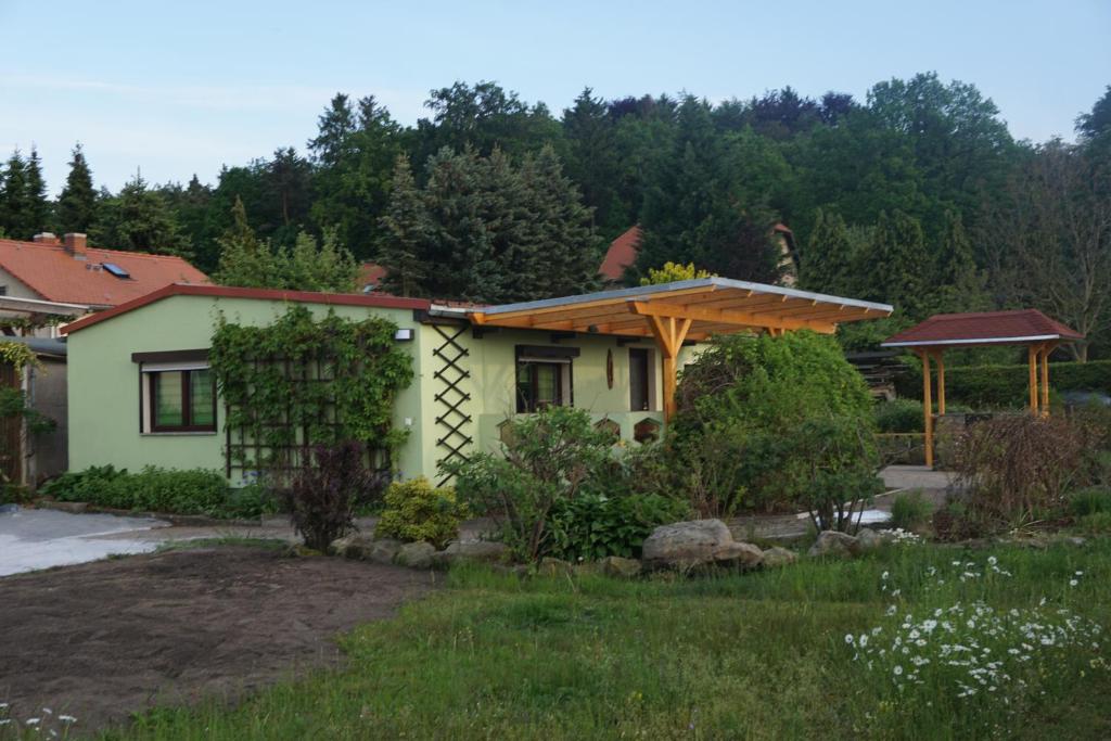 a house with a pergola in a yard at FerienhausTeube in Kurort Gohrisch