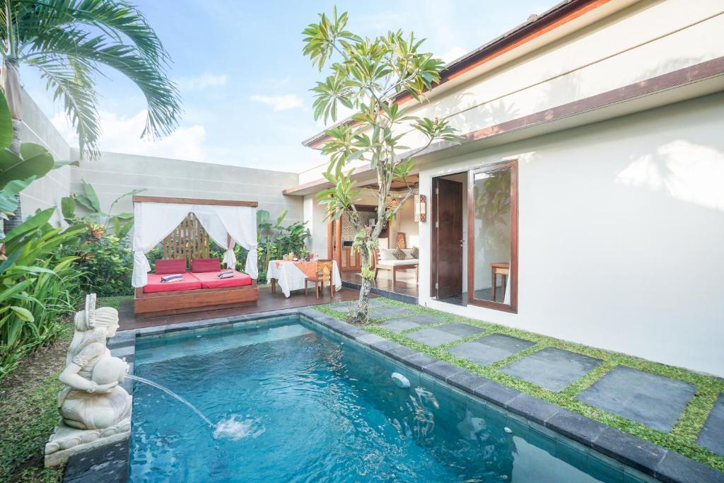 a swimming pool in the backyard of a house at Gaing Mas Jimbaran Villas by Gaing Mas Group in Jimbaran
