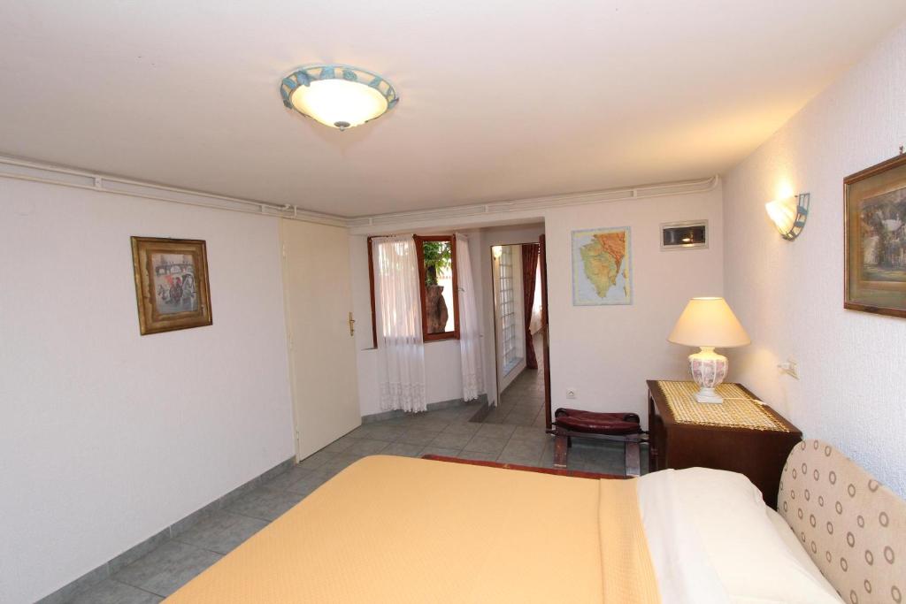 Postel nebo postele na pokoji v ubytování Apartments Villa Lucu