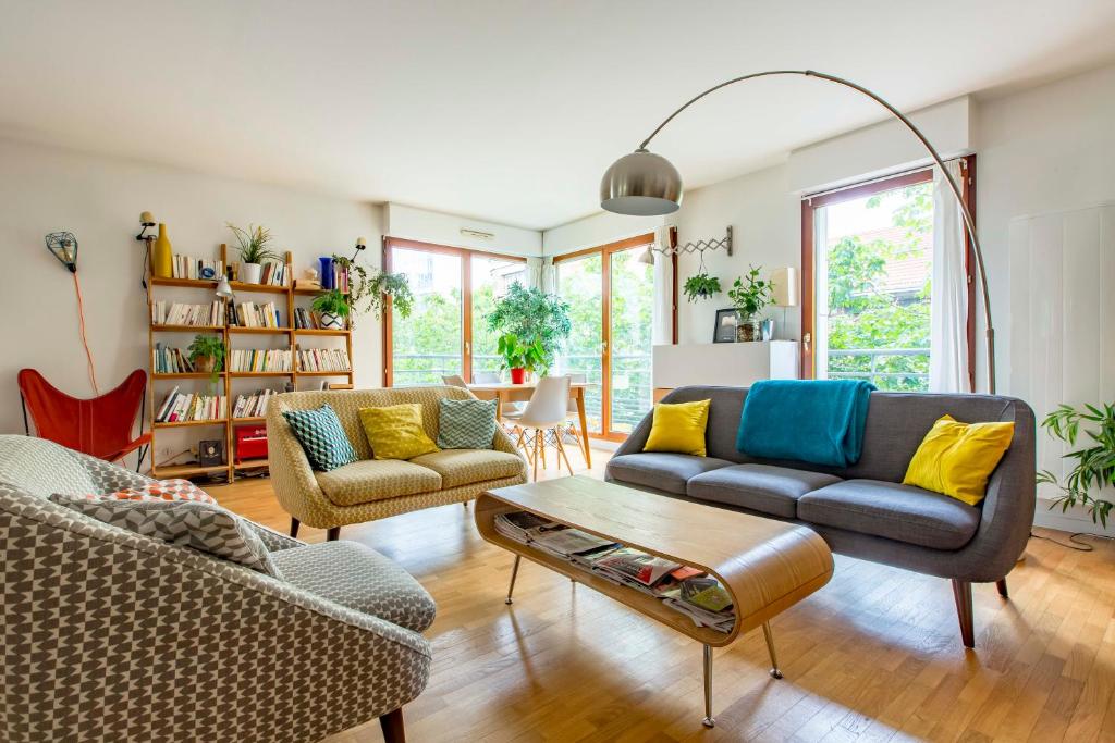 a living room with two couches and a table at Veeve - Modern Brights in Paris