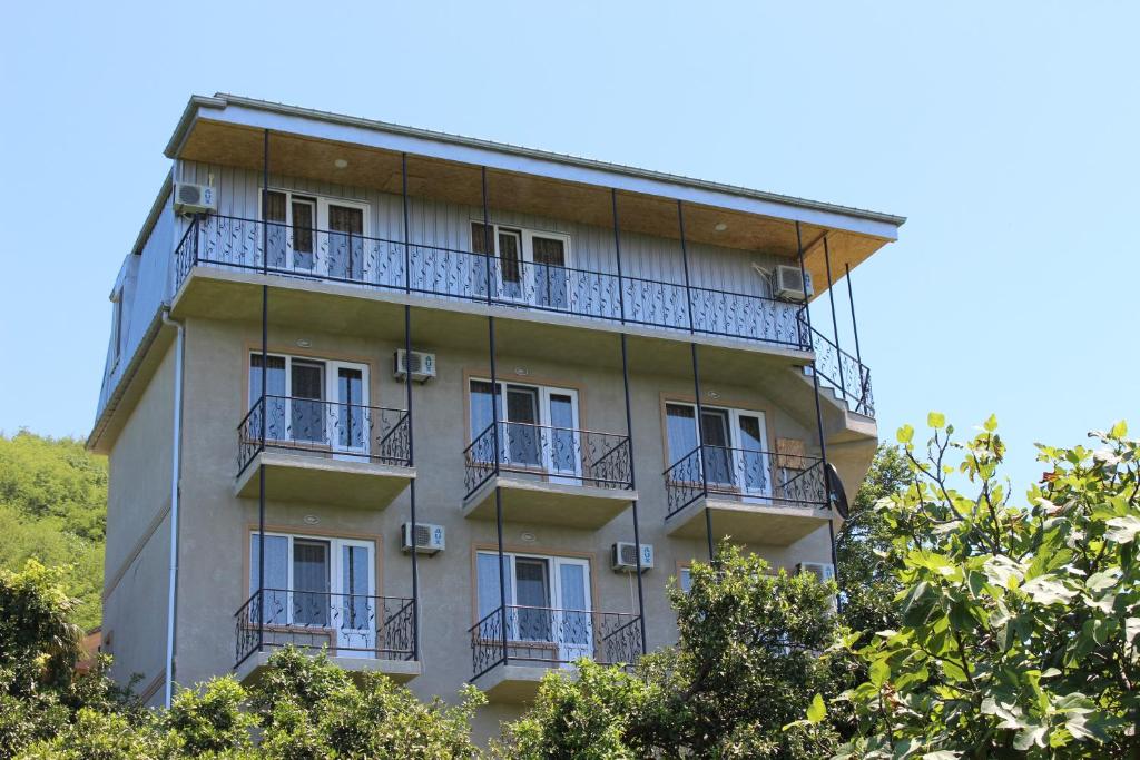 a building with balconies on the side of it at Holiday Home Data in Batumi