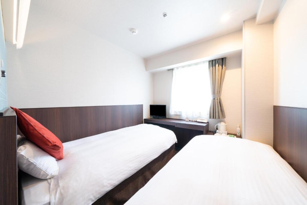 Postel nebo postele na pokoji v ubytování Pearl Hotel Ryogoku