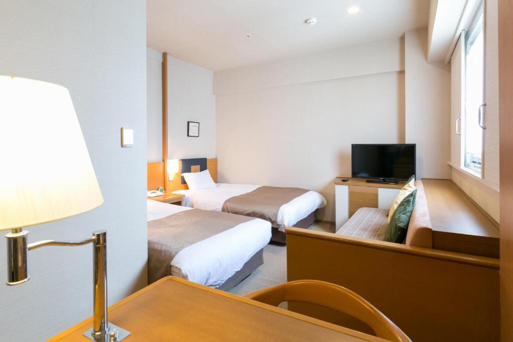 Postel nebo postele na pokoji v ubytování Pearl Hotel Ryogoku
