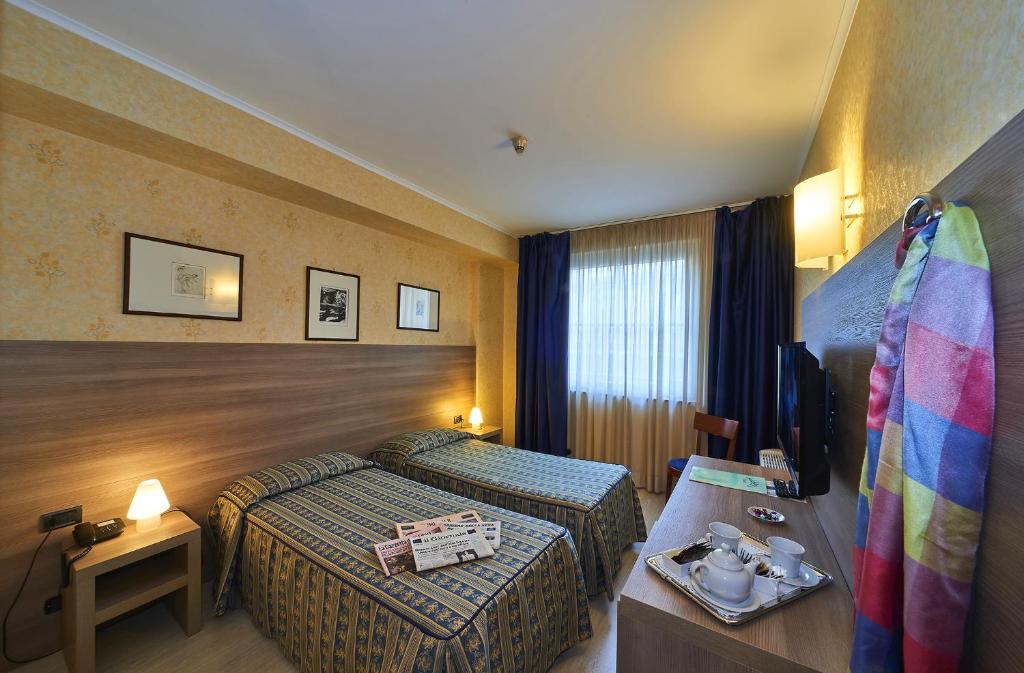 Postel nebo postele na pokoji v ubytování Hotel Alberi